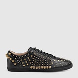 Studded fringe leather sneaker