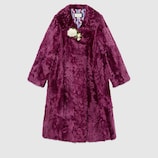 Fur coat with brooch
