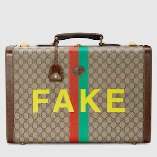 'Fake/Not' print medium suitcase