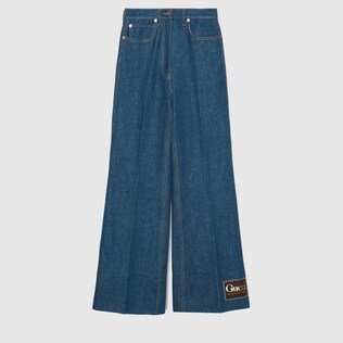 Washed denim flare trousers with Gucci label