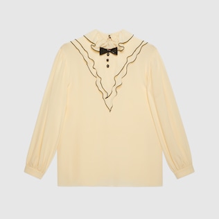 Ruffled silk shirt with bow brooch