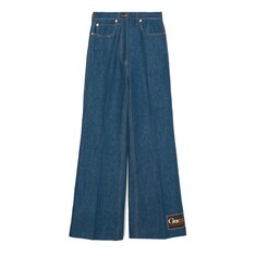 Pantalon évasé en jean délavé avec étiquette Gucci