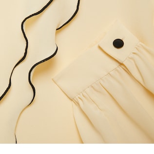 Ruffled silk shirt with bow brooch