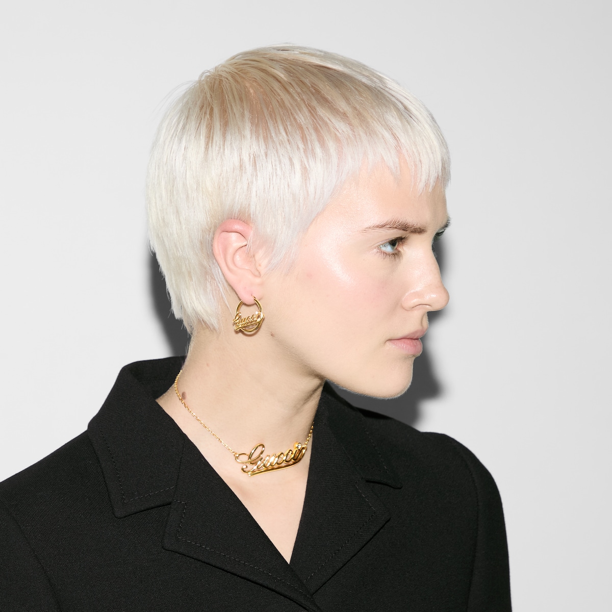 Hoop earrings with Gucci script in yellow gold-toned metal