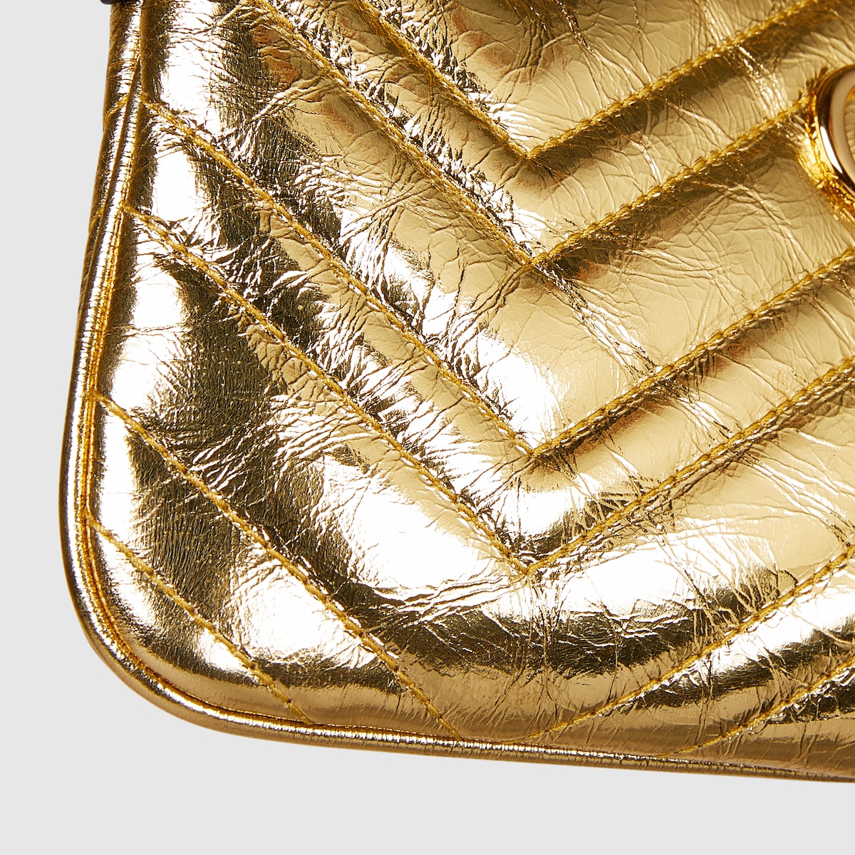 GG Marmont pochette with chain in gold leather | GUCCI® US