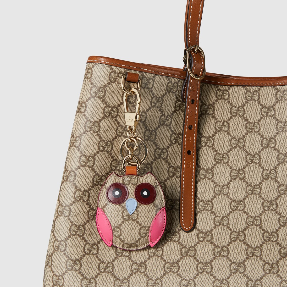 Owl-shaped bag charm in beige and dark brown canvas