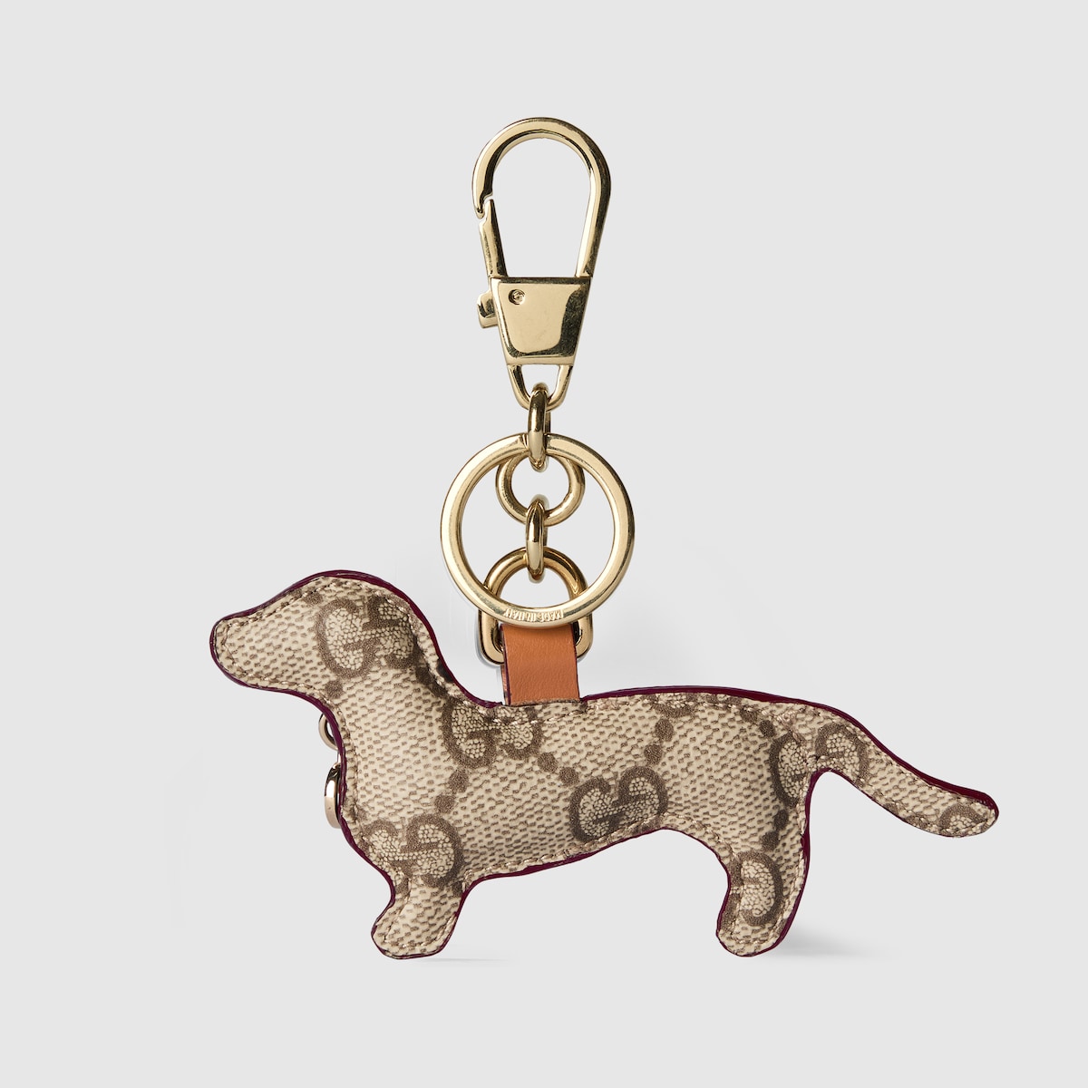 Dog-shaped bag charm in beige and dark brown canvas