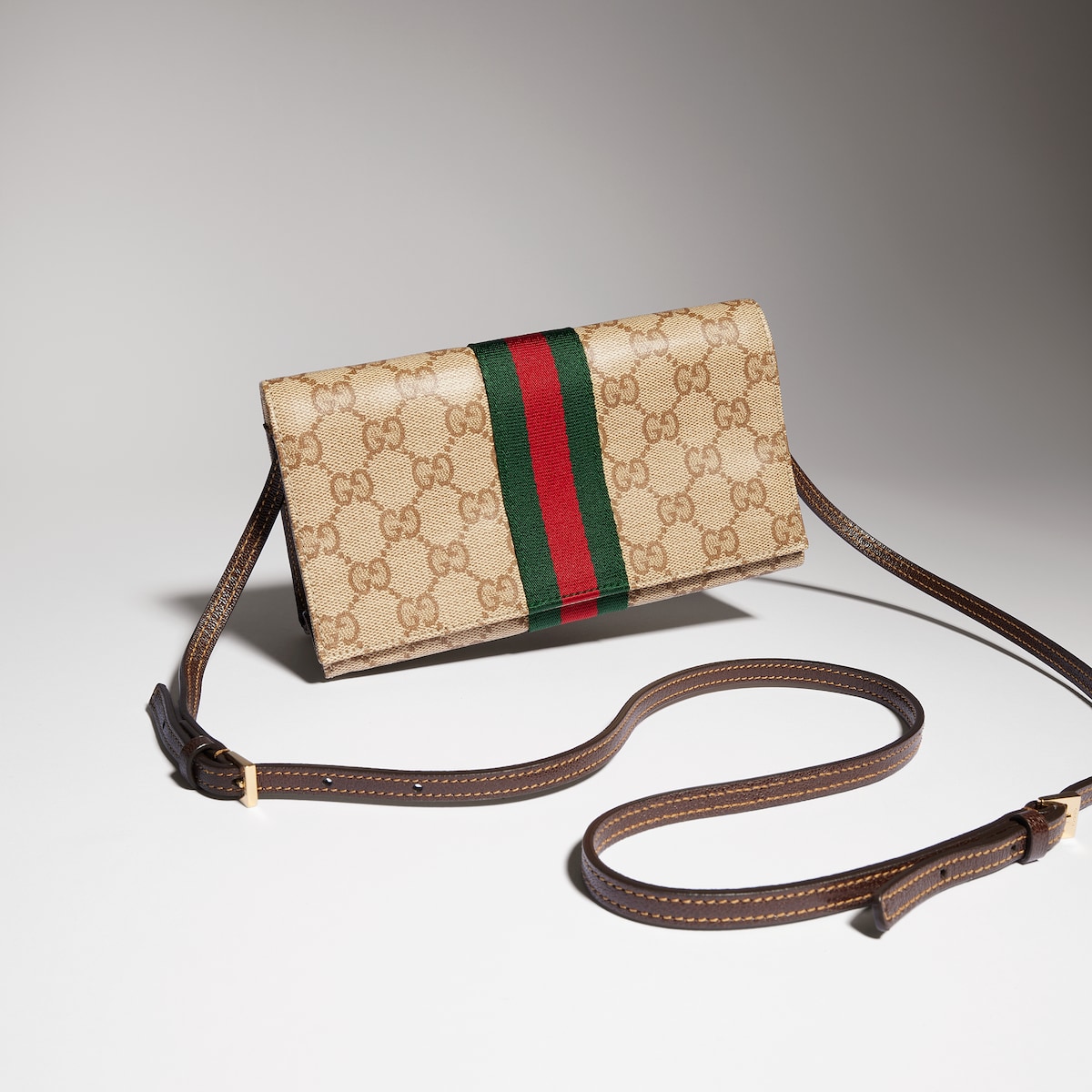 Small pouch with strap and Web in sand and brown GG canvas | GUCCI® US