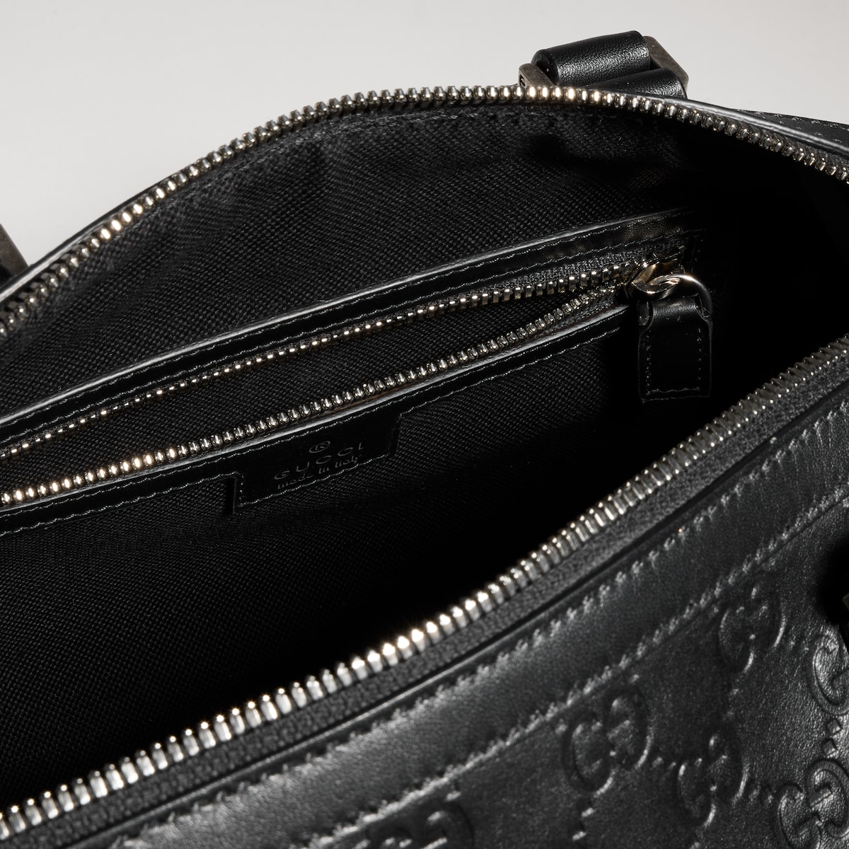 GG Emblem small duffle bag in black GG leather