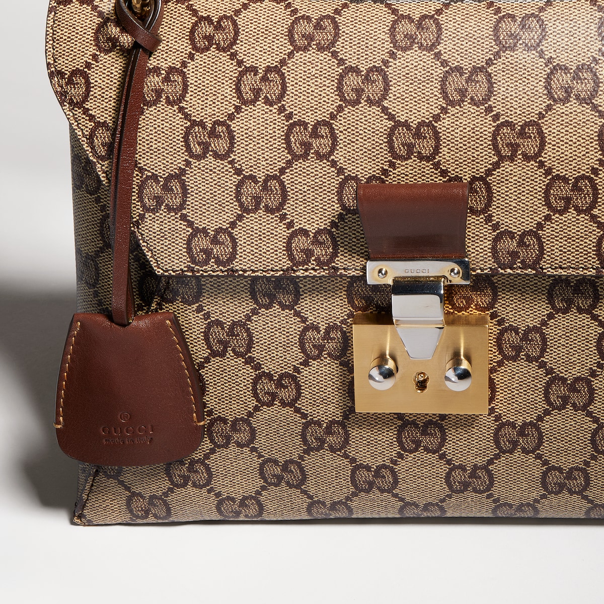 Small top handle bag with lock in beige and dark brown GG canvas ...