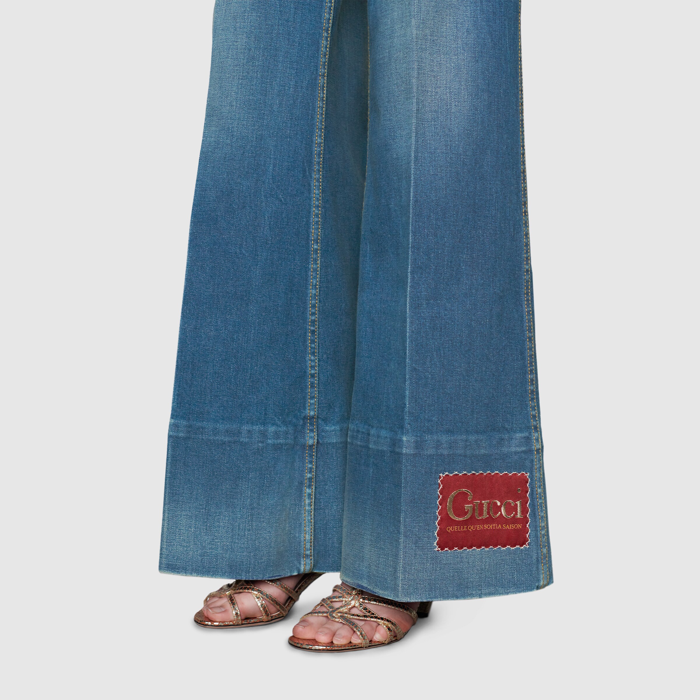 623441_XDA6N_4759_010_100_0000_Light-Washed-denim-flare-trousers-with-Gucci-label.jpg