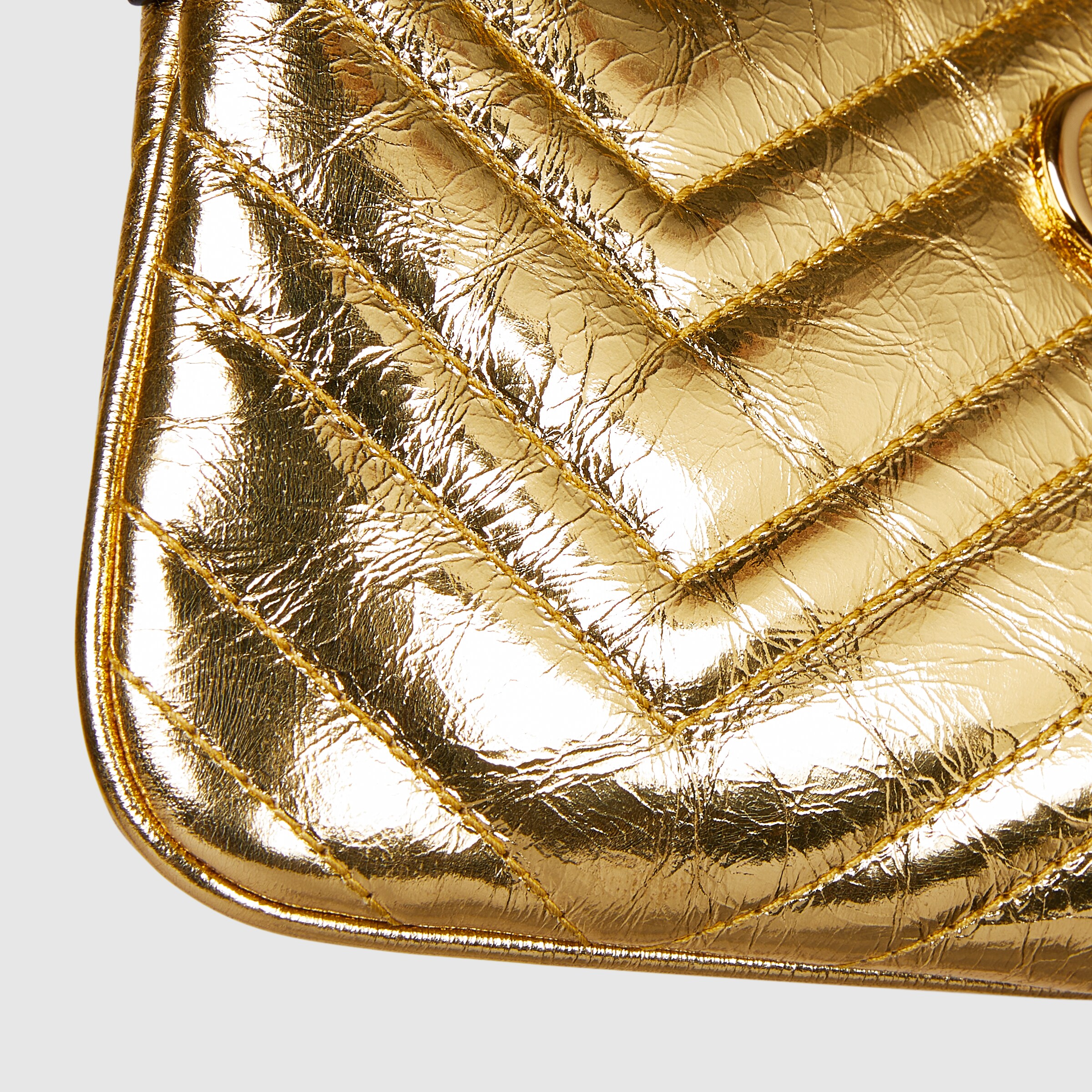 GG Marmont pochette with chain in gold leather | GUCCI® US