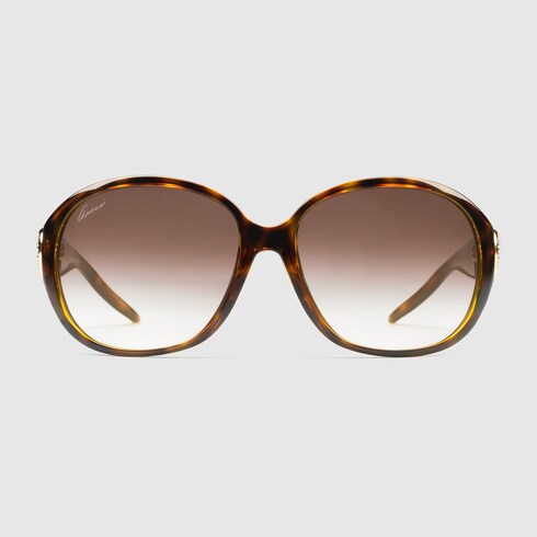 Large frame sunglasses with crystal heart-shaped interlocking G logo.