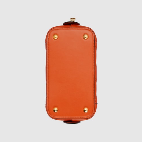 GG Matelassé mini top handle bag in orange leather | GUCCI® SG