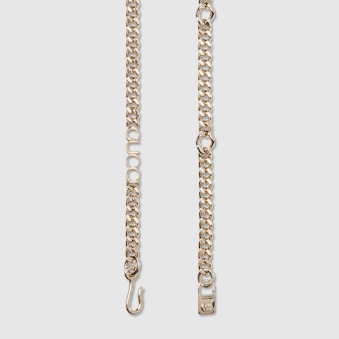Ceinture chaîne avec inscription Gucci 