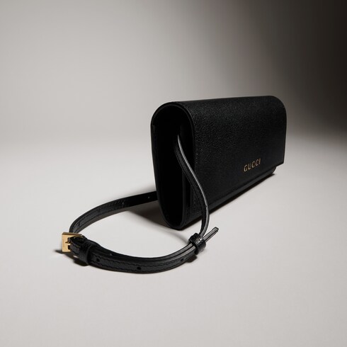Portefeuille avec sangle et inscription Gucci