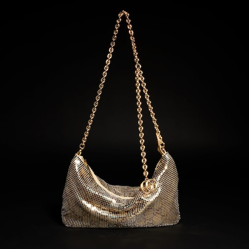 Bolsa de noche metálica con dije
