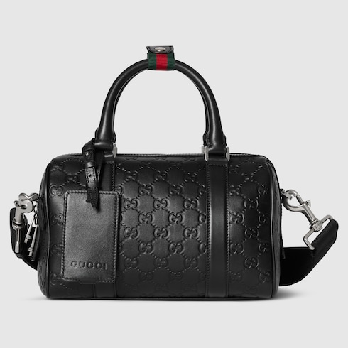 GG Emblem small duffle bag in black GG leather | GUCCI® US