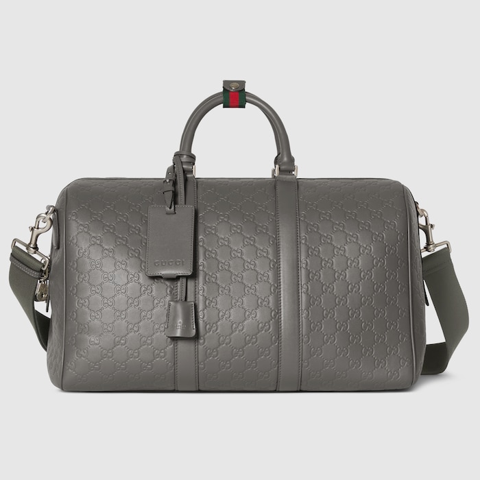 GG Emblem medium duffle bag in grey GG leather | GUCCI® US