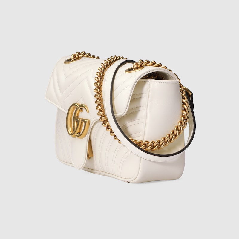 white and gold gucci purse