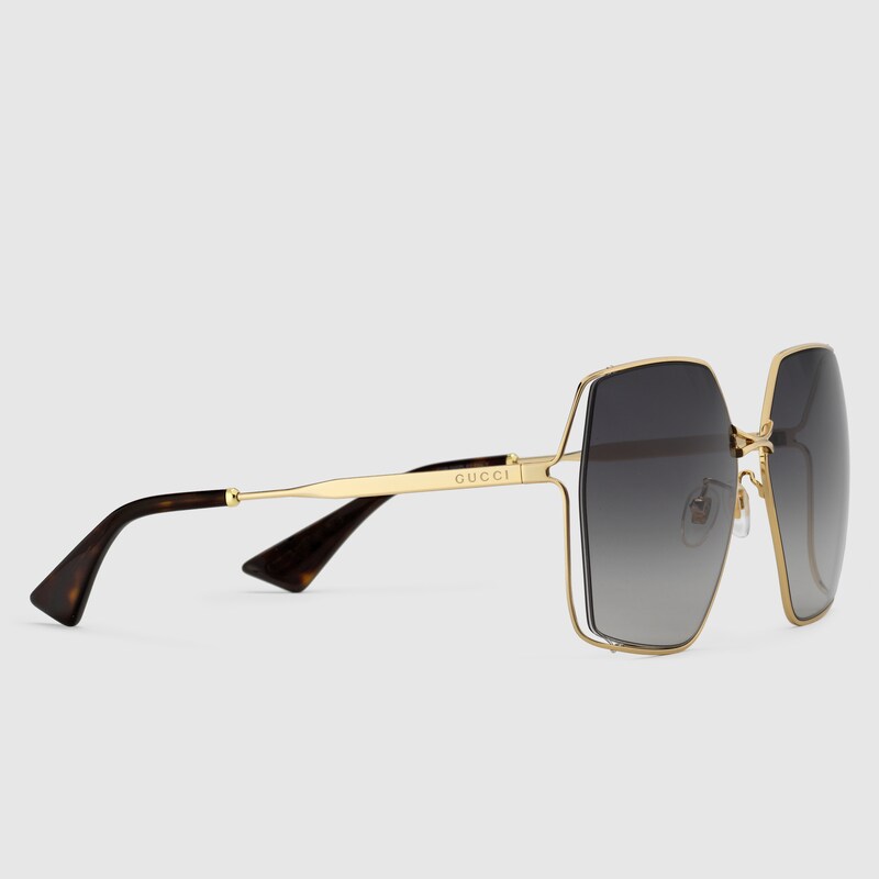 Occhiali da sole ovali in metallo color oro e grigio | GUCCI® Italia