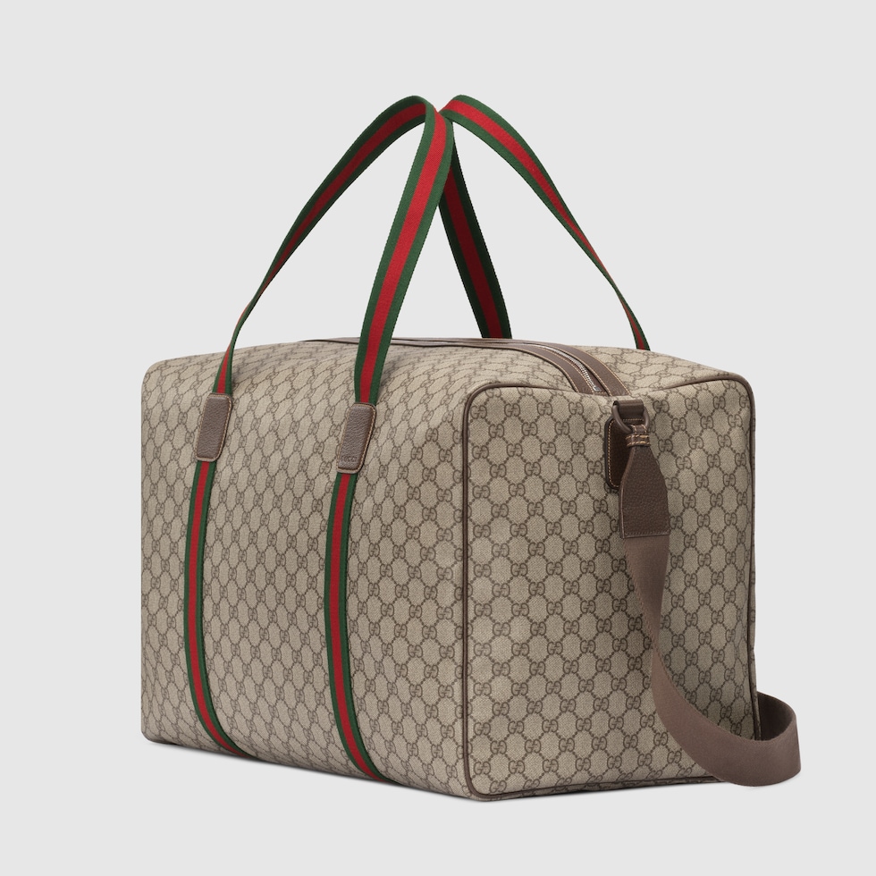 Sac de voyage avec bande Web grande taille en toile GG Supreme souple beige et ebene GUCCI FR