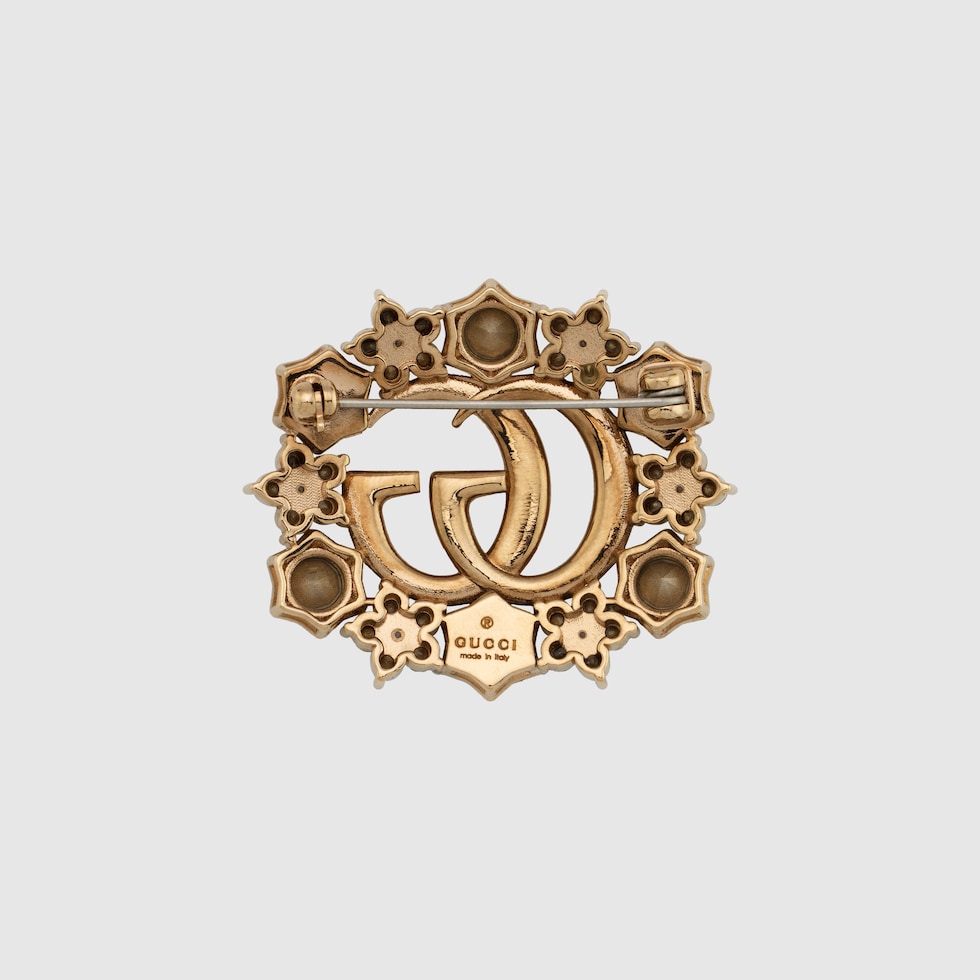 Double G crystal flower brooch in antique gold-toned metal | GUCCI