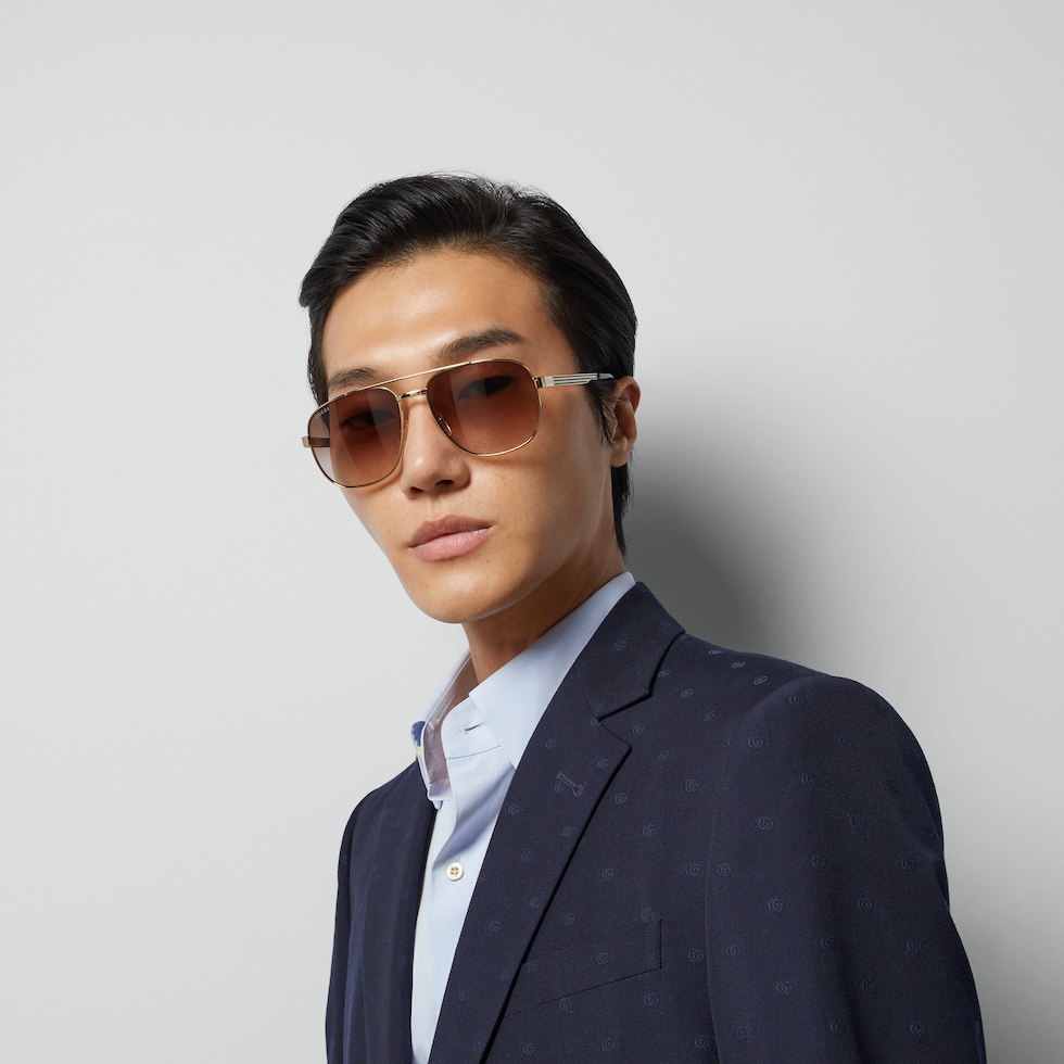 Navigator frame sunglasses in gold-toned metal | GUCCI® US Navigator frame sunglasses in gold-toned metal | GUCCI® US