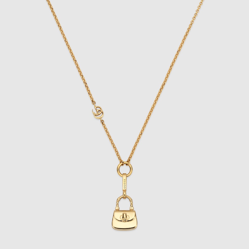 Chain necklace with bag pendant in yellow gold-toned metal