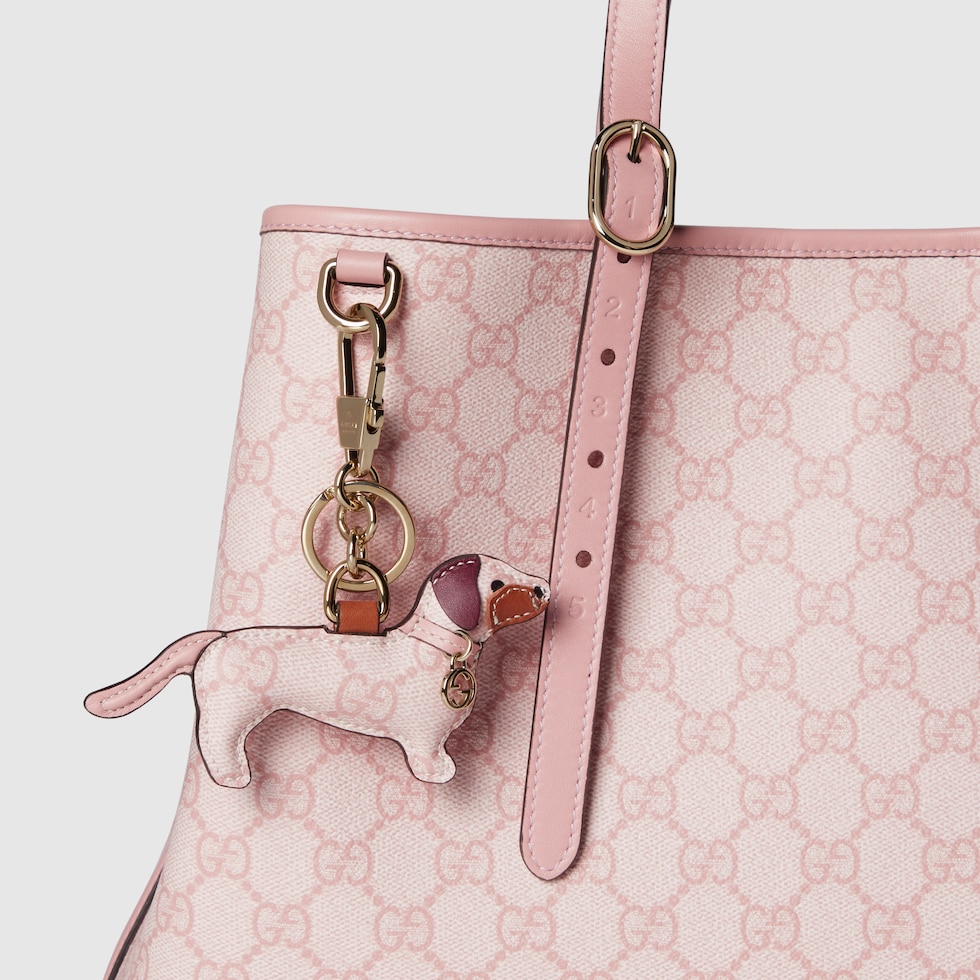 Dog-shaped bag charm in light pink GG Supreme | GUCCI® US Dog-shaped bag charm in light pink GG Supreme | GUCCI® US