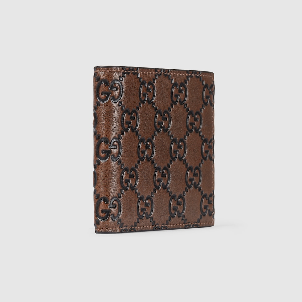 GG Emblem bi-fold wallet in brown and black GG leather | GUCCI® US