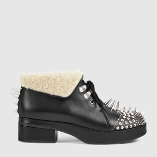 Leather bootie with spikes and studs