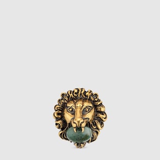 Lion head brooch with glass stone 