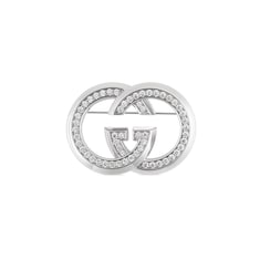 Broche avec détail GG enlacés et cristaux