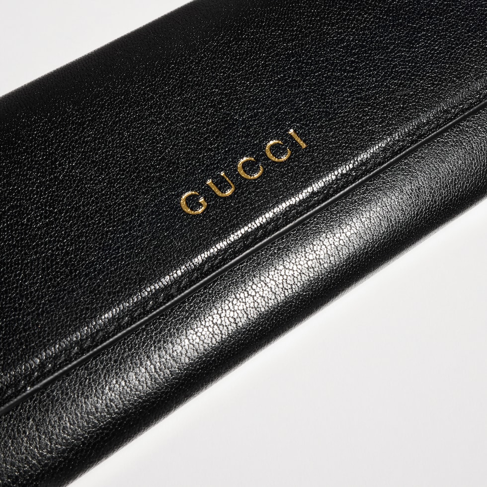 Wallet with strap and Gucci lettering