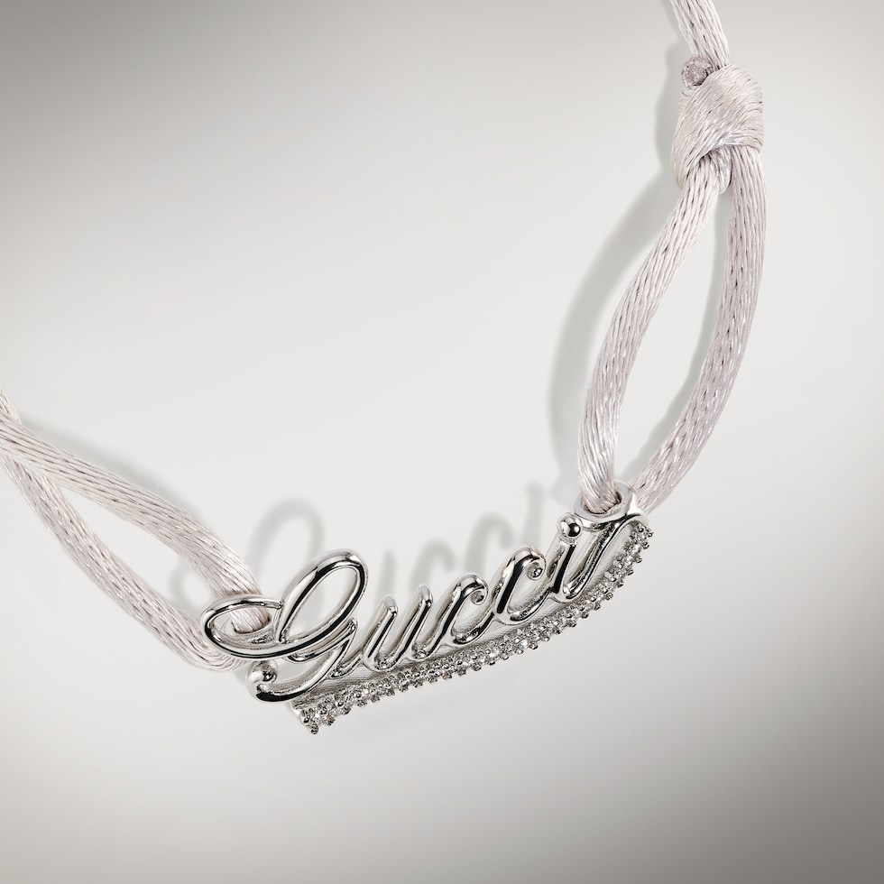 Bracelet cordon avec inscription Gucci et cristaux